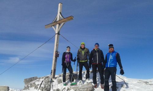 a group of people standing next to a cross on a mountain at Apart Lechtraum in Stanzach