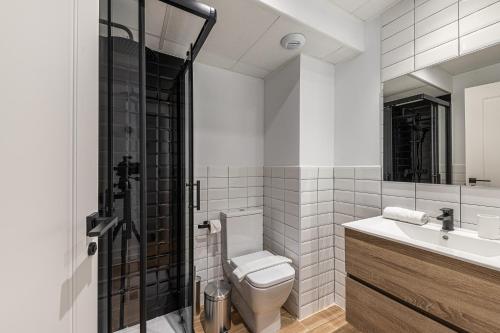 a bathroom with a toilet and a sink and a shower at BNBHolder Best II Madrid Rio in Madrid