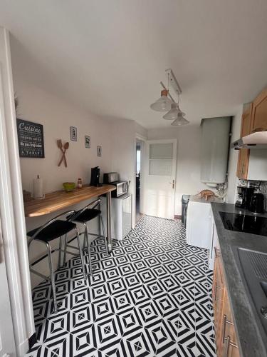 a kitchen with a black and white tile floor at Fenêtre sur mer in Le Portel