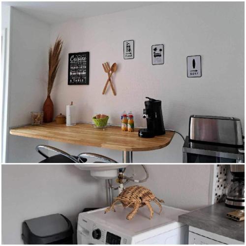 a kitchen with a table on top of a microwave at Fenêtre sur mer in Le Portel