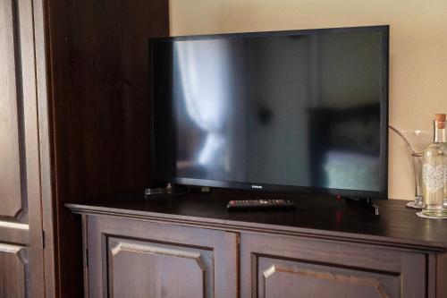 a large flat screen tv sitting on top of a cabinet at Къща ЕТНО in Koprivshtitsa