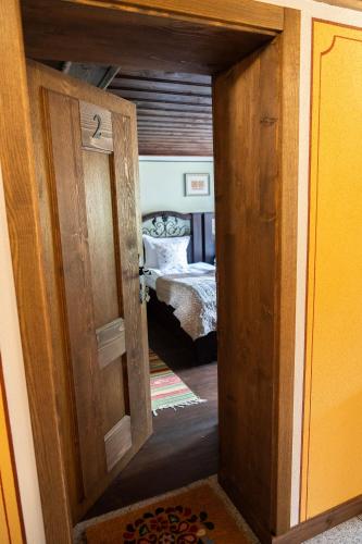a door leading into a bedroom with a bed at Къща ЕТНО in Koprivshtitsa