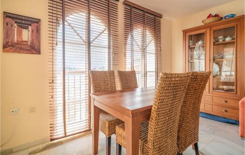 a dining room with a wooden table and chairs at 2 Bedroom Gorgeous Apartment In Málaga in Málaga