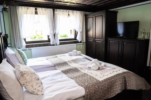 a bedroom with a large bed with towels on it at Къща ЕТНО in Koprivshtitsa