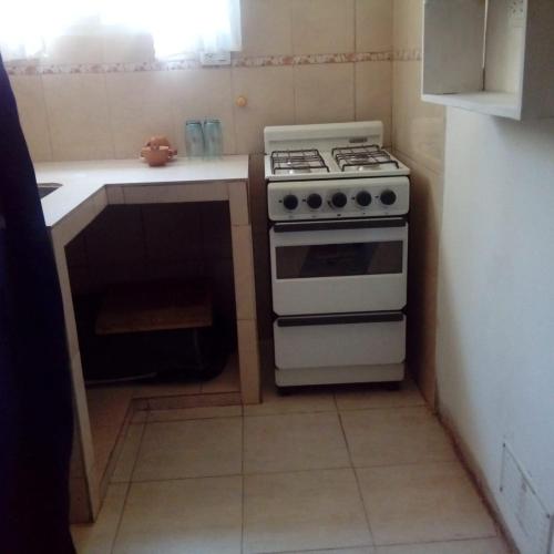 a kitchen with a white stove and a counter at los jacarandaes in San Isidro