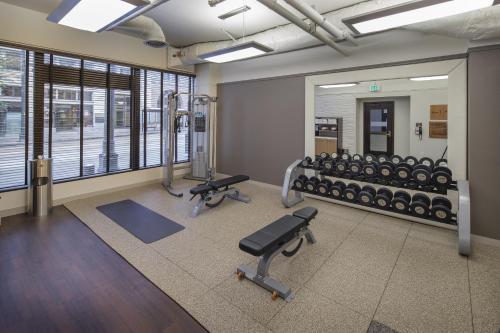 a gym with a row of exercise equipment and mirrors at Arctic Club Hotel in Seattle