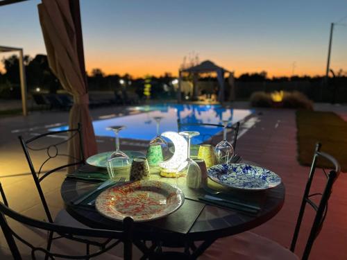 a table with plates of food on it next to a pool at Le stanze di chiara in Torre Lapillo