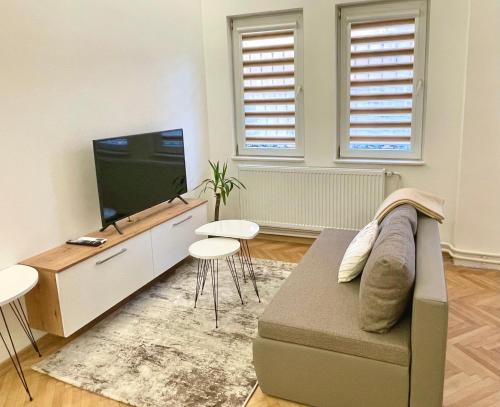 a living room with a couch and a flat screen tv at Rio Studio by Sienna in Skopje