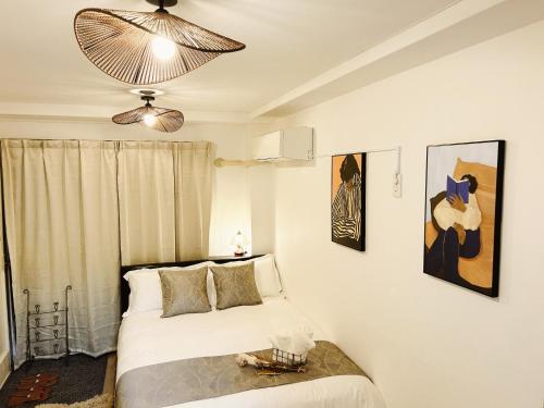 a bedroom with a bed and a chandelier at Tokyo Louis House in Ueno area close to JR Yamanote Line & Metro Ginza Line walk to Ueno Park and Ameyoko in Tokyo
