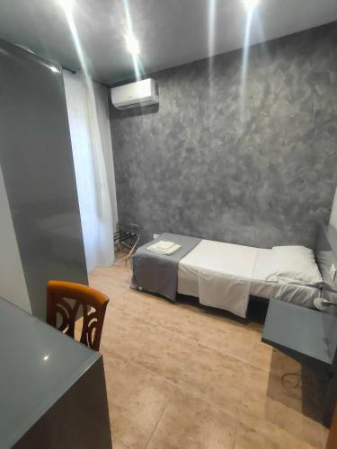 a small room with a bed and a table at Hotel Convertini in Milan