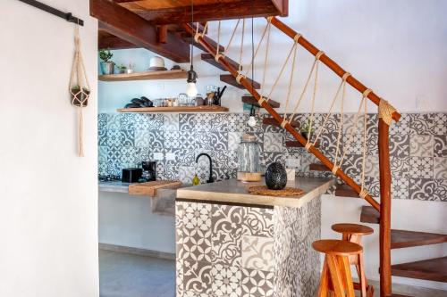 a kitchen with black and white wallpaper and a counter at Ca Nikte Cabañas in El Cuyo