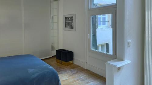 a bedroom with a bed and a window at Maison de ville avec sa cour au calme à 1min de la Pace Stanislas in Nancy