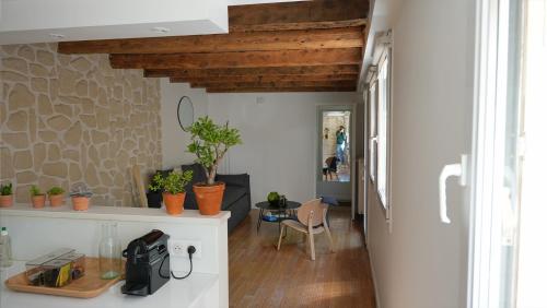 a living room with wooden ceilings and a table at Maison de ville avec sa cour au calme à 1min de la Pace Stanislas in Nancy