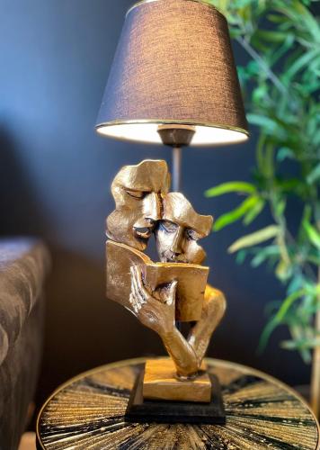 a lamp on a table with a man reading a book at * Chic Business Evasion * - SOnights in Brétigny-sur-Orge