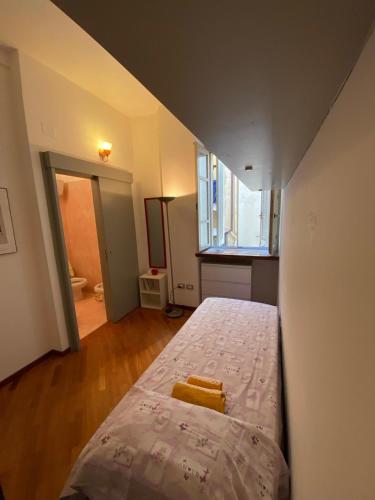 a small bedroom with a bed in a room at PM 2 Via Scano Guest House B in Sassari
