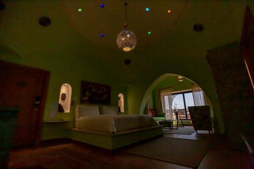 a living room with a bed and a chandelier at Lazib Inn Resort & Spa in Tunis