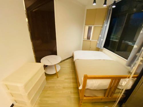 a small room with two beds and a table at Yama house in Tokyo