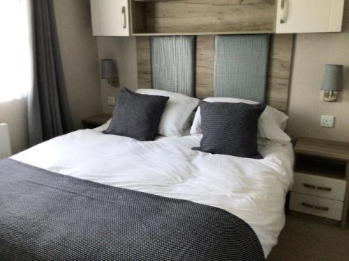 a bedroom with a large bed with two pillows at Luna Retreat - Newbiggin by the Sea in Newbiggin-by-the-Sea