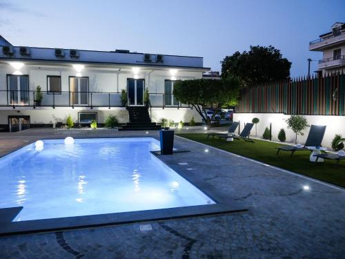 a swimming pool in front of a house at Maison de Julia Pompei in Pompei