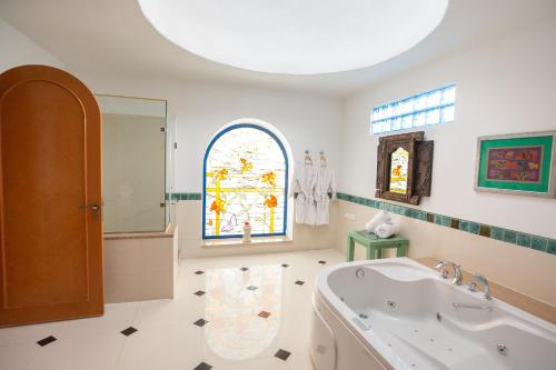 a bathroom with a tub and a stained glass window at Lazib Inn Resort & Spa in Tunis