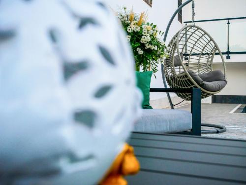 a close up of a rocking chair and flowers at Maison de Julia Pompei in Pompei
