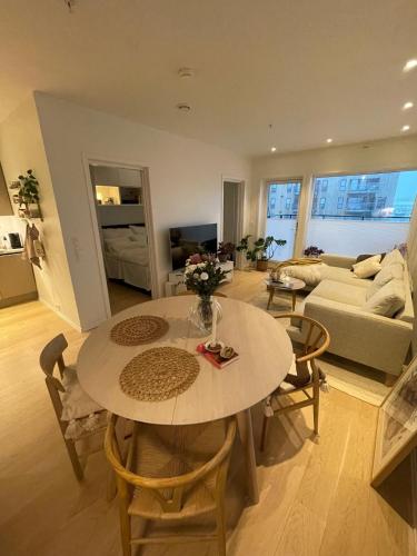 uma sala de estar com uma mesa e um sofá em Modern apartment nearby city centrum em Tromsø