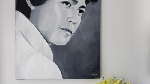 a painting of a woman with a pen in her mouth at Shintana Saya La Maison in Siem Reap