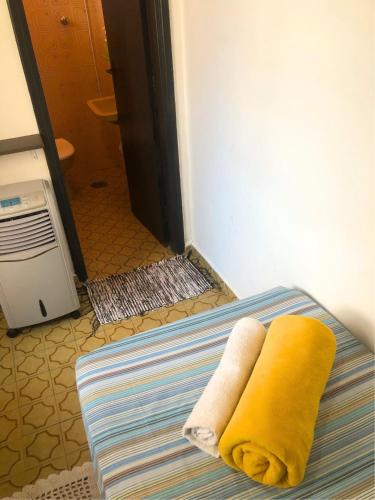 a pair of towels sitting on a bed at Micasa Hostel - Congonhas in Sao Paulo
