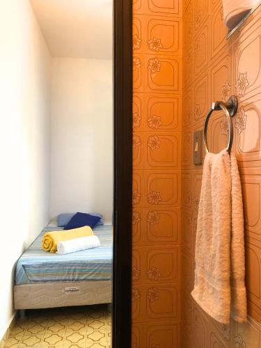 a bedroom with a bed and a door with a towel at Micasa Hostel - Congonhas in Sao Paulo