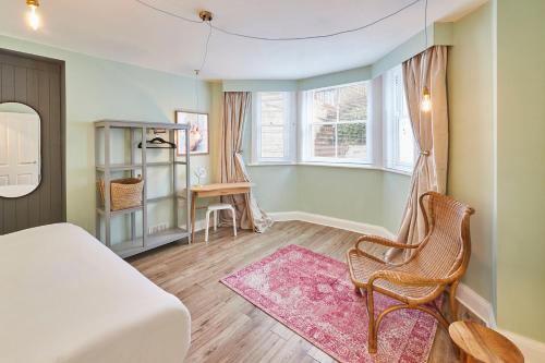 a bedroom with a bed and a chair and a desk at South Bay Garden Apartment in Scarborough