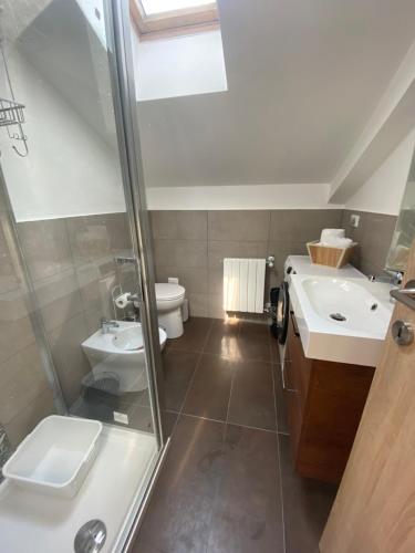 a bathroom with a shower and a toilet and a sink at Happyhouse in Turin