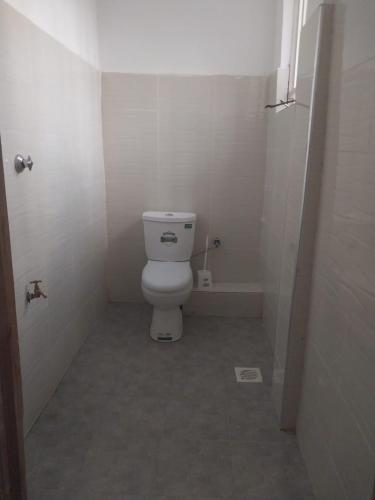a small bathroom with a toilet and a shower at White House Resort 