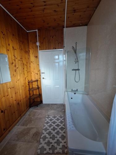 a bathroom with a white tub and a shower at Maryann's in Huddersfield