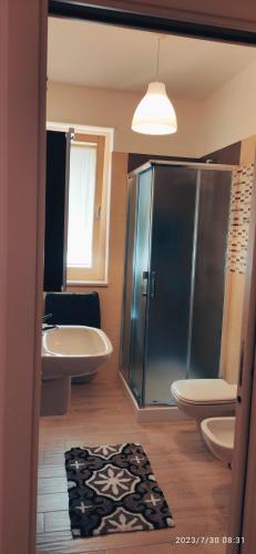 a bathroom with a shower and a toilet and a sink at mono polis apartment in Monopoli