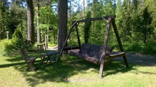 a swing and two chairs sitting in a yard at Villa Tammikko in Tuusula