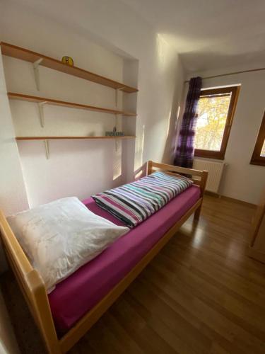 a bedroom with a bed in a room with a window at Apartman Željo in Livno
