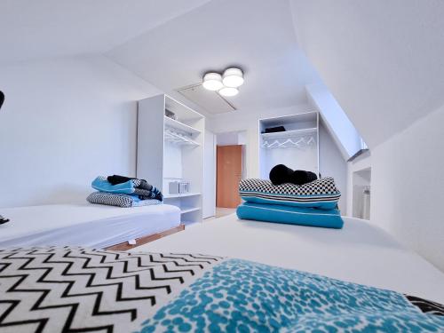 a bedroom with two beds with blue and white at Alpha Apartments in Krefeld