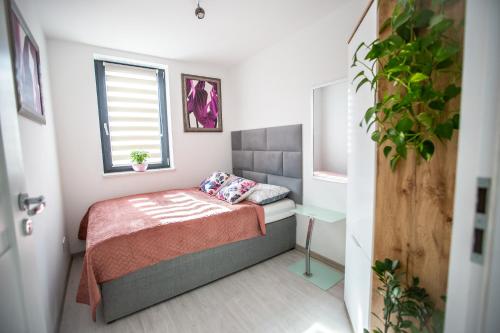 a small bedroom with a bed and a window at Wlodarska 4a Lux Premium in Krakow