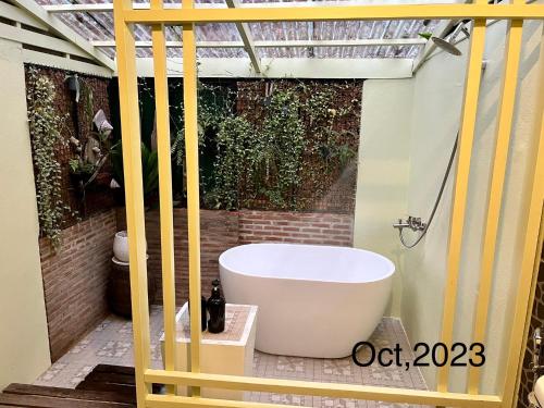 a bathroom with a tub on a patio at Baan Bua Cottage SHA EXTRA PLUS B5510 in Ko Kood