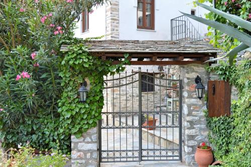 an entrance to a house with an iron gate at Archontiko Argyro in Makrinítsa