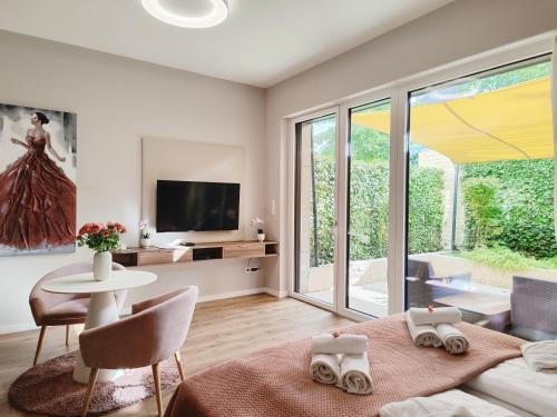 Televízia a/alebo spoločenská miestnosť v ubytovaní Spa Residence Carbona Mona Lila Apartman