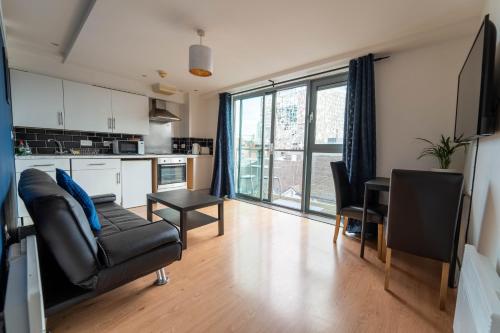 a living room with a couch and a table at Broad Street -Central-Couples-1 Bedroom Apartment in Birmingham