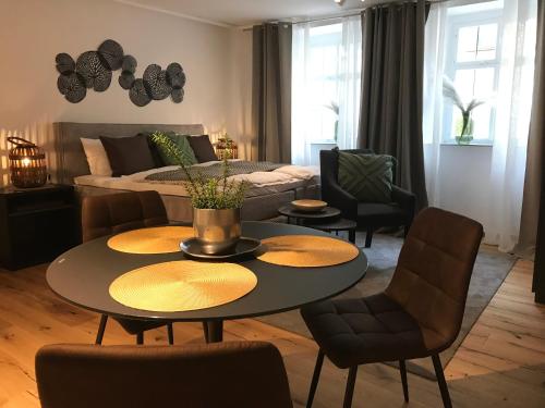 a living room with a table and chairs and a couch at Hotel Herrnschloesschen in Rothenburg ob der Tauber