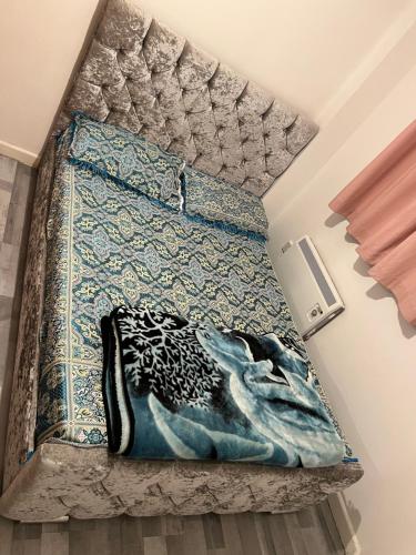a bedroom with a bed with a mermaid rug at Room in the centre of Portsmouth in Portsmouth
