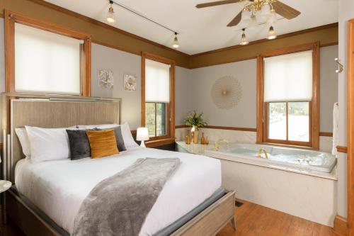 a bedroom with a bed and a bath tub at Riverboat Suites in Galena