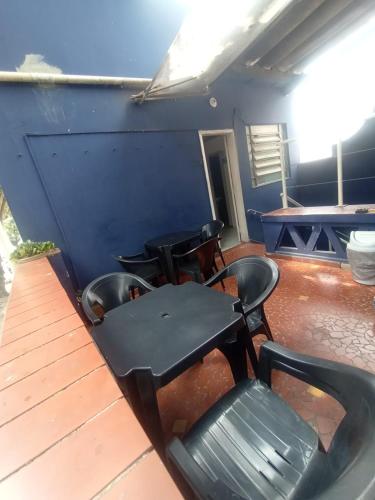 a table and chairs sitting on a wooden deck at Hostel Maktub in Sao Paulo