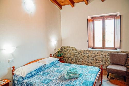 Ένα ή περισσότερα κρεβάτια σε δωμάτιο στο Agriturismo Rocce Bianche