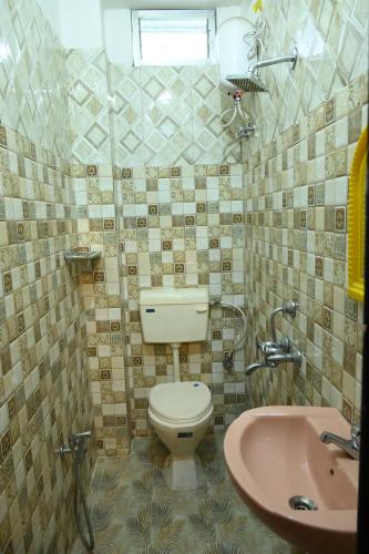 a bathroom with a toilet and a sink at HOTEL BEACH A/C in Port Blair