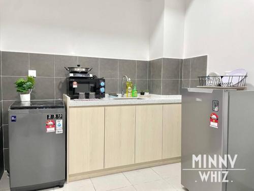 a kitchen with a stove and a refrigerator in it at Netizen Balcony View MRT 4-5pax #17 in Cheras