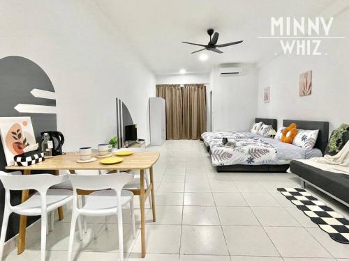 a living room with a table and a bed at Netizen Balcony View MRT 4-5pax #17 in Cheras